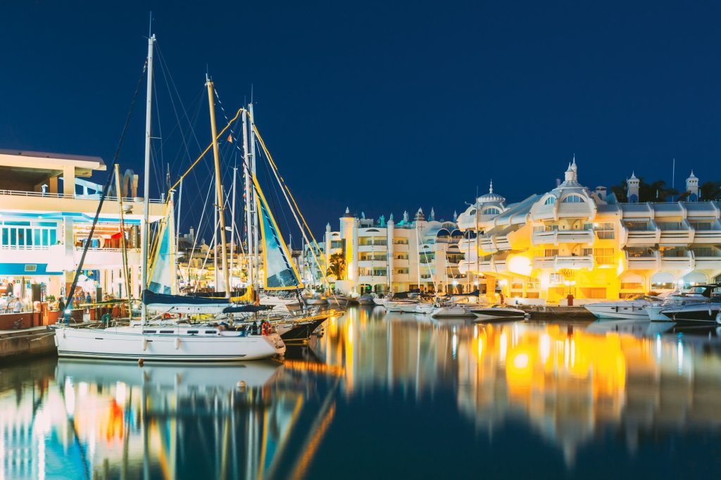Benalmadena, Spain. Night Scenery View Of Floating Houses, Vessel In Puerto Marina. Malaga Region