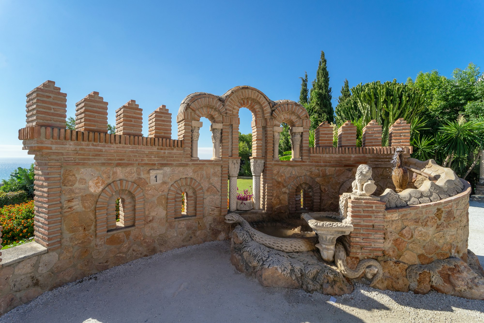Monument and part of the castle of colomares on a clear summer day with blue sky. Benalmadena.